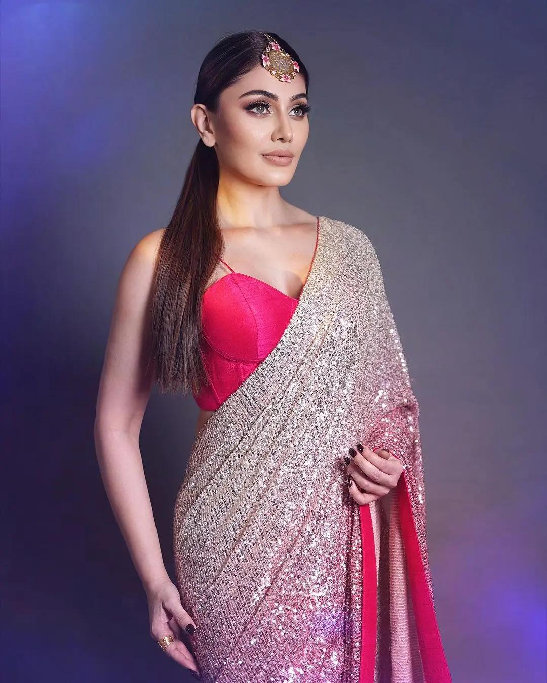 For a lightweight yet stylish look at your relative`s wedding, take inspiration from Shefali`s elegant choice. Opt for a beautiful pink sequin saree paired with a matching blouse