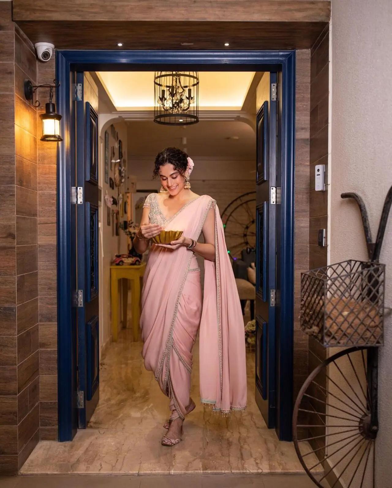 Taapsee wore a pink Marathi-style saree for her Diwali celebration. She styled her hair in a fun updo and adorned it with gajra