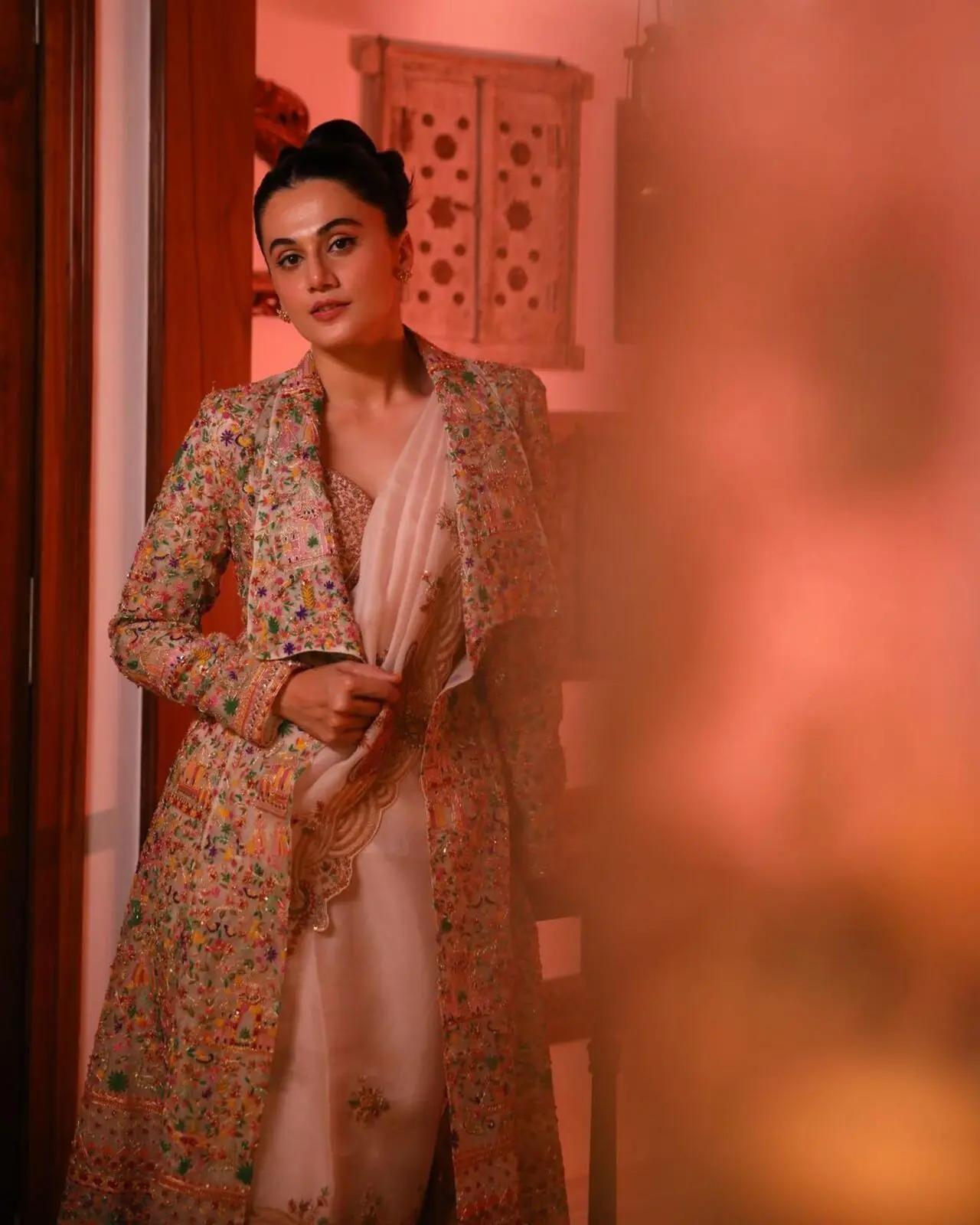 It`s not easy to experiment with a saree without making a mistake, but Taapsee knows how to pull it off. She paired a peach saree with a decorated blazer