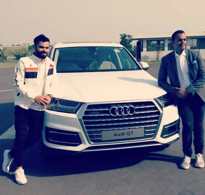 In picture: Virat Kohli poses besides his Audi Q7 car.