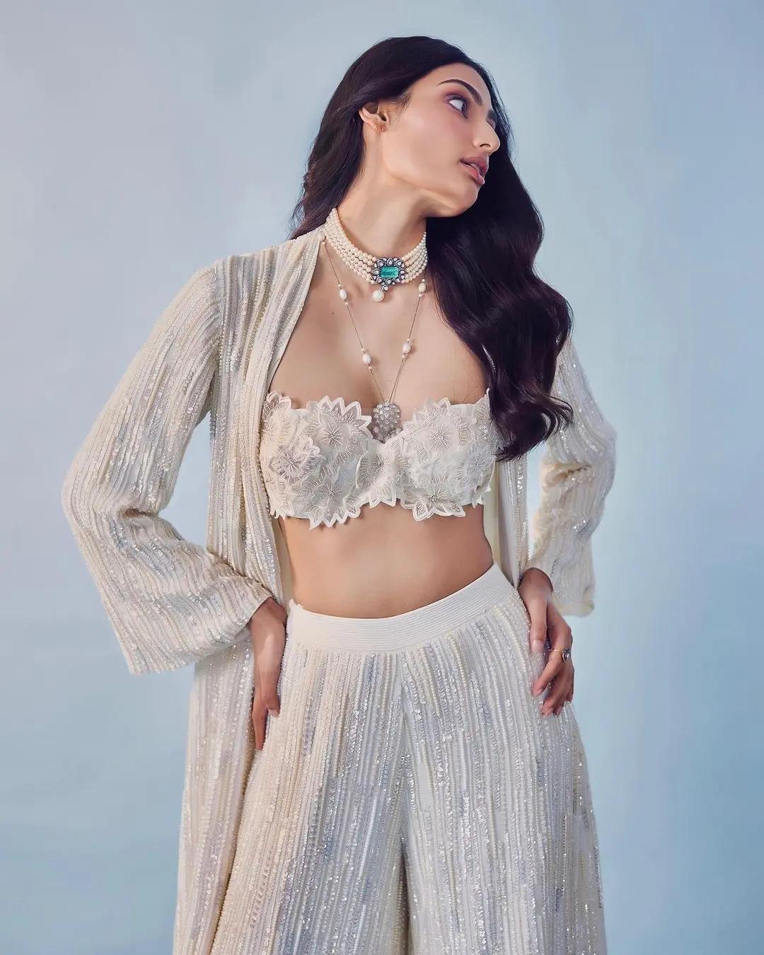 Over it, she had on a long jacket that matched the palazzo pants and was decorated with ivory sequins and pearls