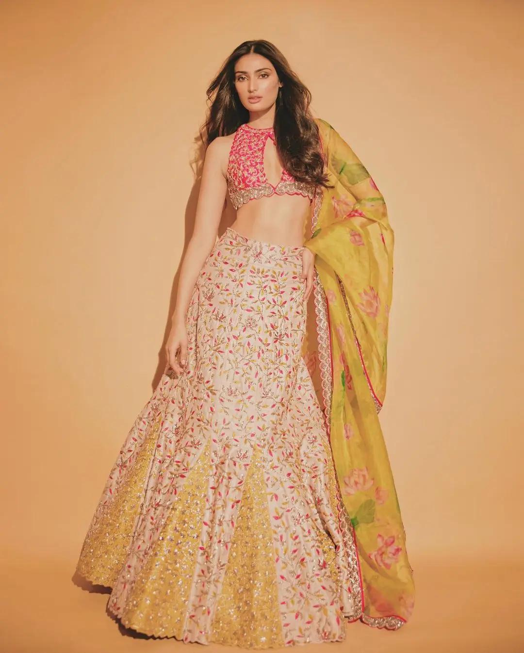 It`s time to up your game this Diwali 2023! Athiya Shetty`s ethnic wardrobe gives us the perfect inspiration for the festive season. For instance, this coral lehenga set is the perfect mix of contemporary and traditional. The top is a chic halter neck with a floral printed skirt