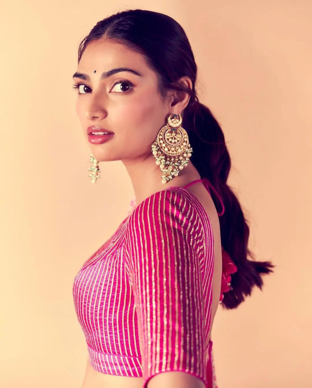She paired the lehenga with statement jhumkas and a striking bindi