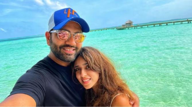 With his wife Ritika Sajdeh, the two posing before the vastness of the ocean.