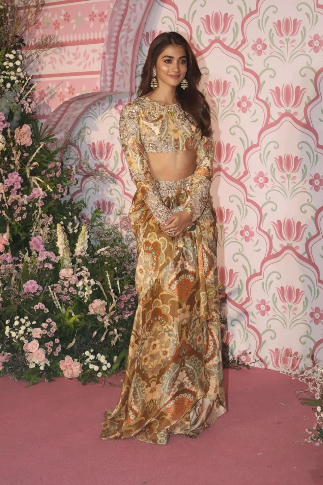 Pooja Hegde upped the glam quotient in this two piece stylish gold lehenga