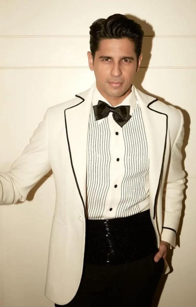  Exudes timeless sophistication in his fashion choices. Whether it`s a classic suit or a casual outfit, Malhotra`s style is marked by refined elegance.
