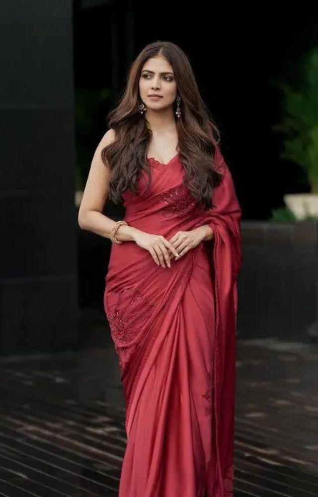 She wowed in a stunning red saree featuring embroidered floral designs, paired with a glamorous statement-back cutout blouse, subtle makeup, and soft, wavy hair