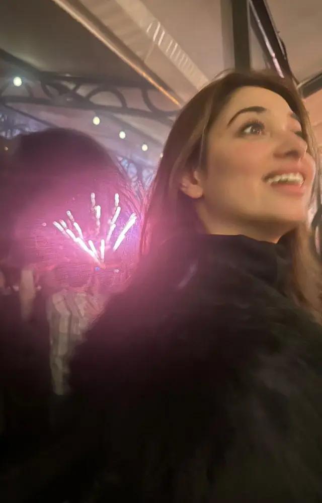 Fireworks can be seen in the background of this picture as Tamannaah relishes the moment
