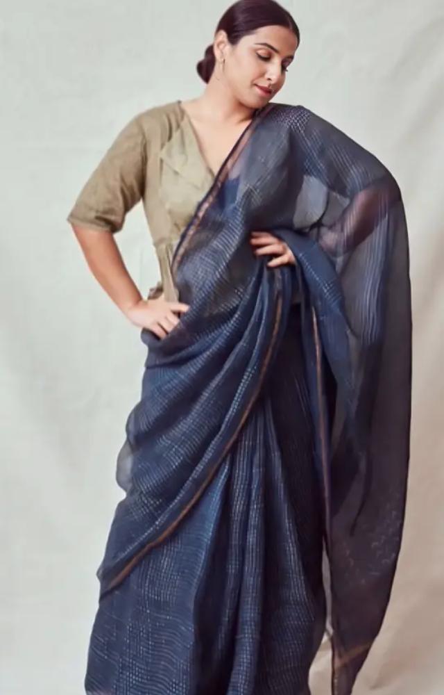 Vidya chose a stylish approach in draping her saree by opting for a vibrant blue colour. She paired it with a stunningly contrasting cream blouse.