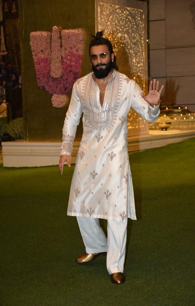 Ranveer Singh looked dapper in a white and gold kurti, classy shades, and a man bun.