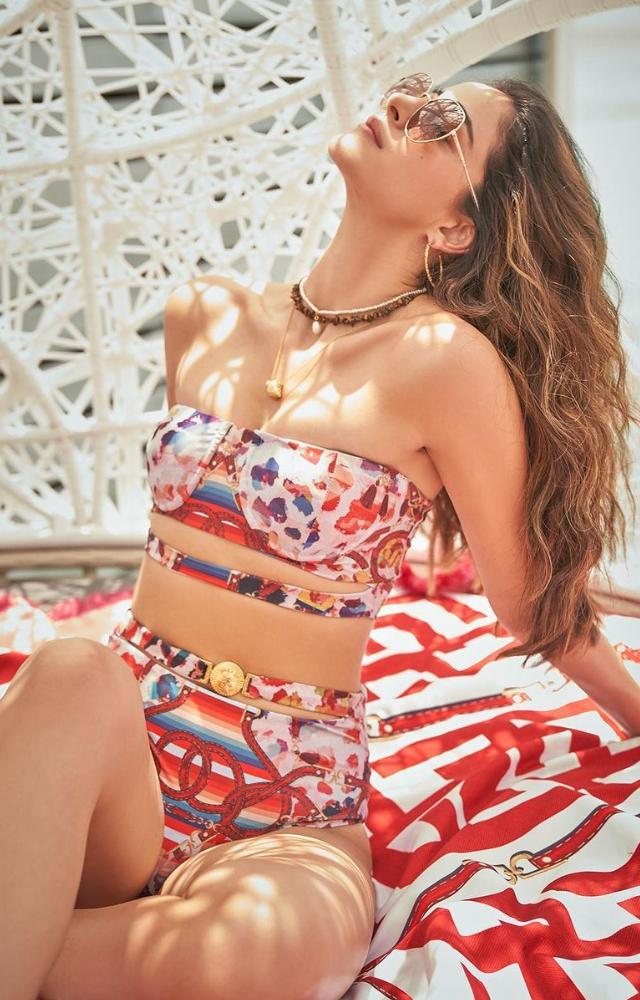 Ananya embraces modern swimwear trends, flaunting cutout swimsuits and ombré designs paired with stylish sarongs.