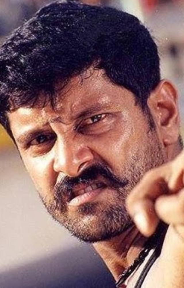 A ruthless vigilante in Dhool, displaying his intense and menacing side.