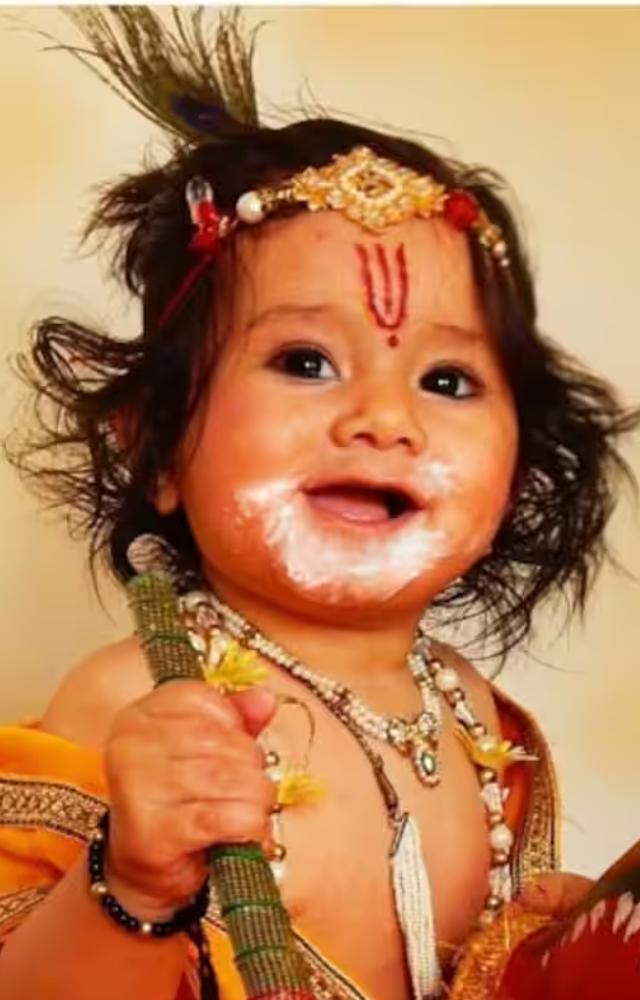 Dress Krishna in elaborate, colorful garments such as silk sarees or dhotis with intricate embroidery, often complemented by a peacock feather crown.