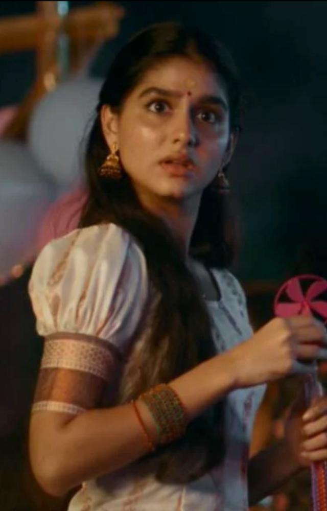 The tension builds as Gopi appears on-screen, walking out of a police station with visible injuries.