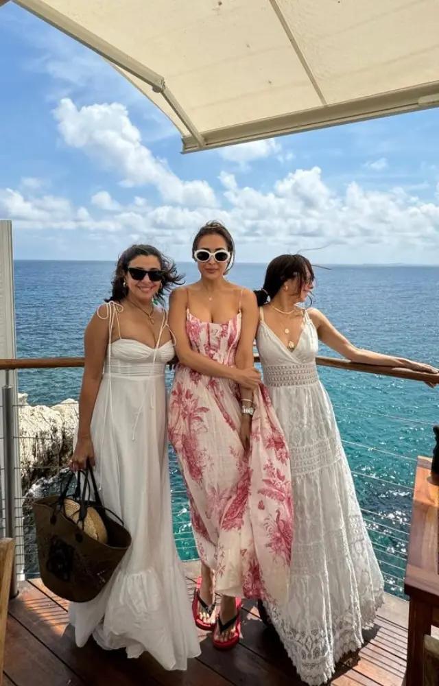 Malaika wore a gorgeous red and white floral maxi dress while she was on the cruise with her gal pals.