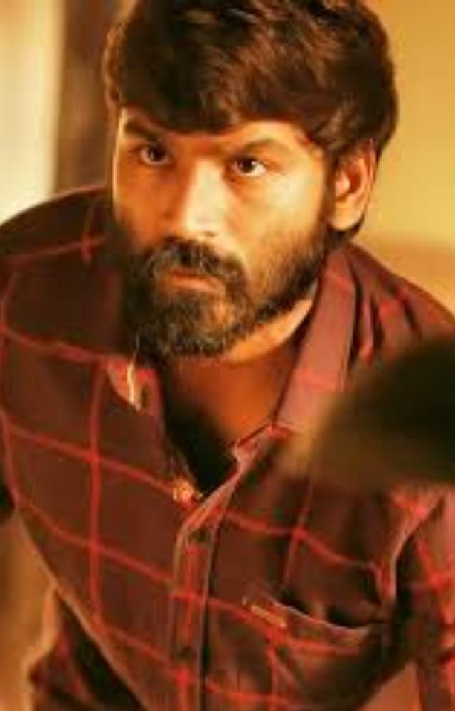 A raw gangster epic with brutal knife fights, caste wars, and Vetrimaaran’s gritty realism. Dhanush’s rage is unforgettable.