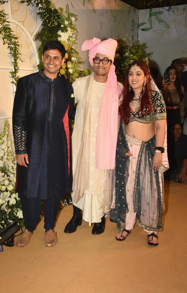 Proud papa Aamir Khan poses with newlyweds Ira Khan and Nupur Shikhare. The couple got married on Wednesday at the Taj Lands Ends in Mumbai.