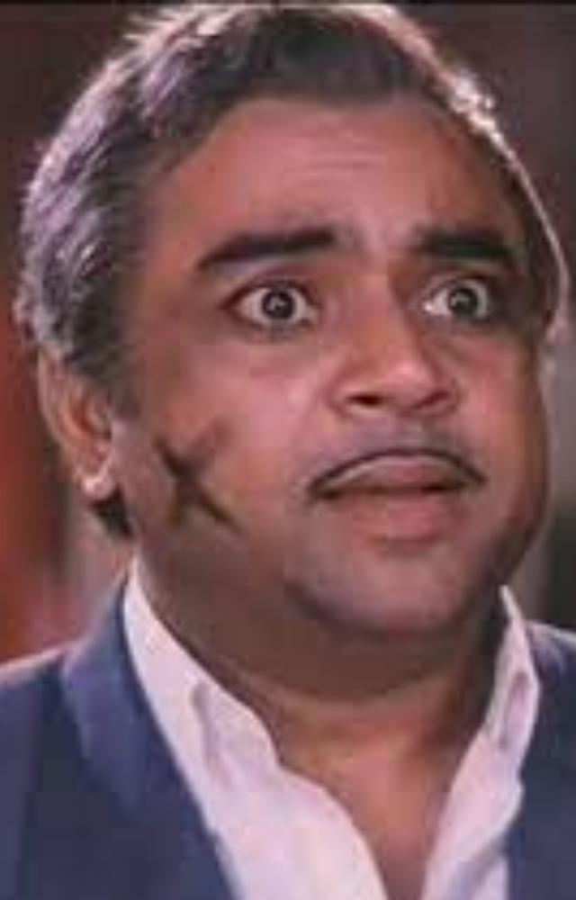 He portrayed a comedic gangster, often confused with his twin brother which adds to the chaos. His quirky mannerisms and dialogues make him unforgettable.