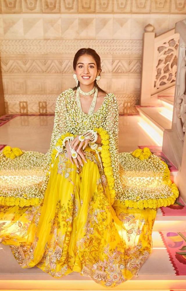 The bride-to-be had an elaborate haldi ceremony where she wore a stunning yellow dress and a dupatta made with gorgeous yellow and white flowers.