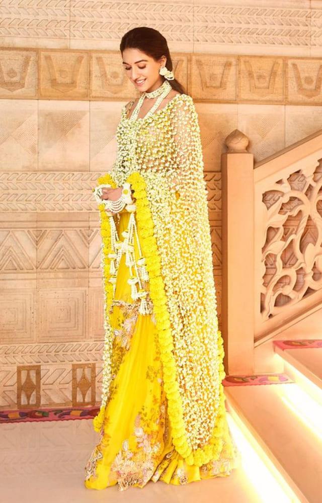 It was the iconic Bollywood stylist, Rhea Kapoor, who styled Anant Ambani`s to-be wife for her haldi ceremony. She took inspiration from natural, real flowers.
