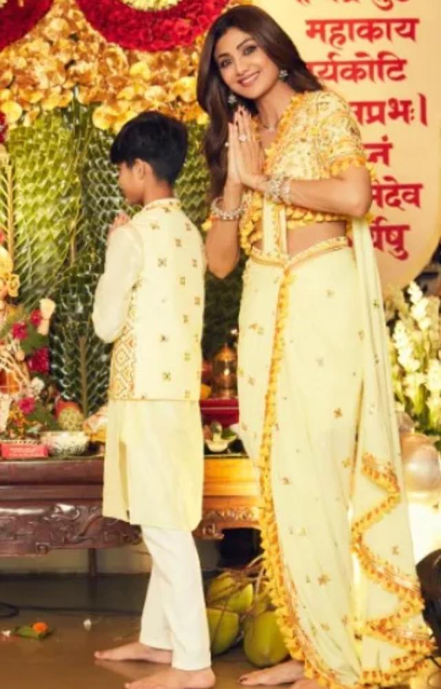 Shilpa`s yellow nauvari saree looks elegant with a gold border decorated with tassels. Pair it with a Maharashtrian nose ring for a perfect ethnic look.