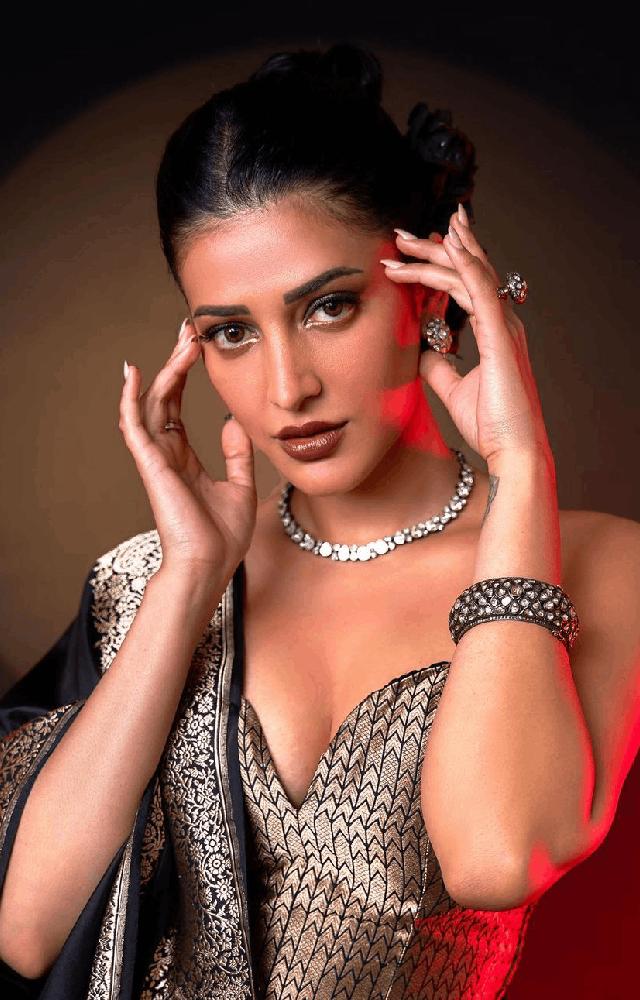 the actress flaunts a silk black saree with silver embroidery, coupled with a corset-style blouse, embodying a captivating blend of style and elegance