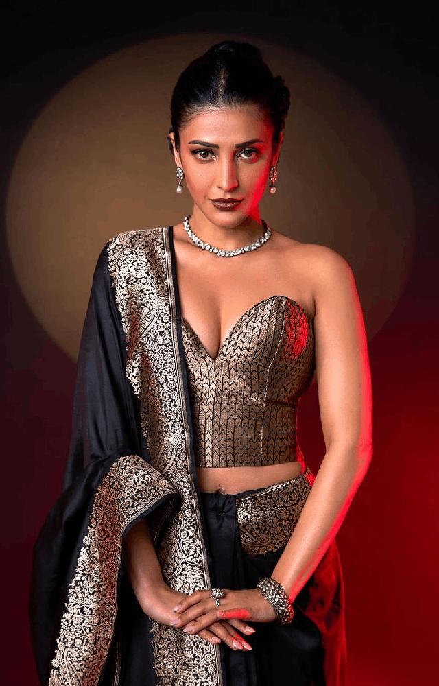 Shruti Haasan steals the spotlight in a silk black saree adorned with silver intricacies, showcasing a perfect blend of contemporary style and traditional allur