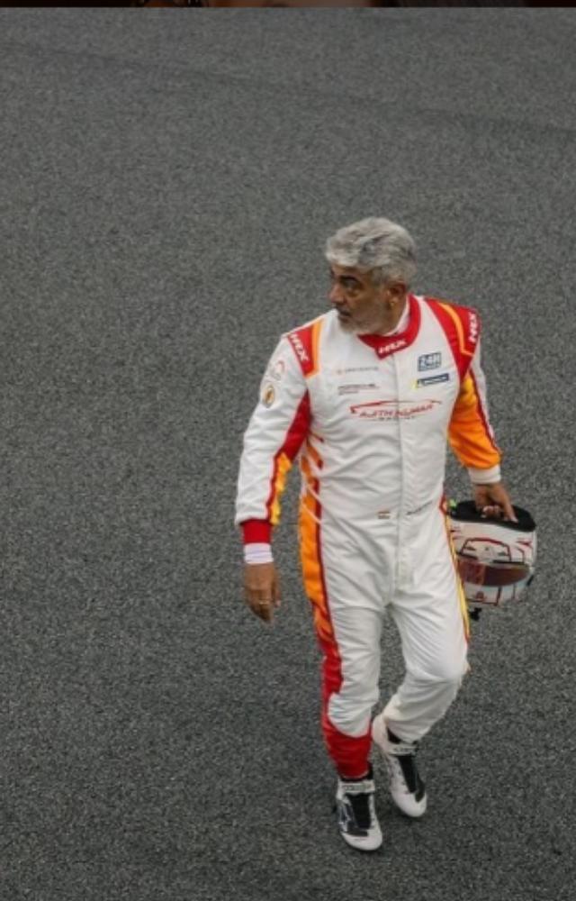 He was seen wearing racing gear and posing with his custom car, which features his name prominently on the front