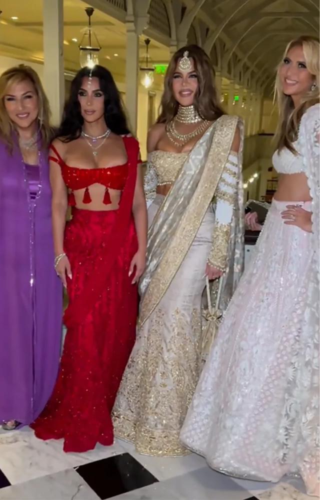The sisters dazzled in traditional Indian attire: Kim chose a vibrant red lehenga, while Khloé radiated regal elegance in a golden saree