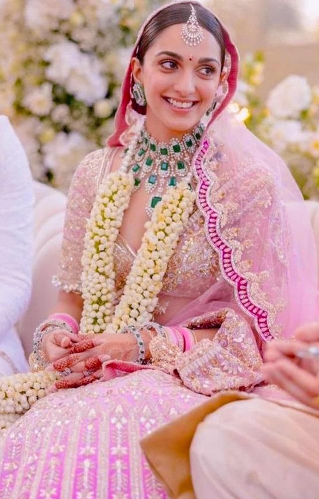 Kiara Advani shines with bridal radiance in Manish Malhotra`s designs, making her wedding a true fashion statement.