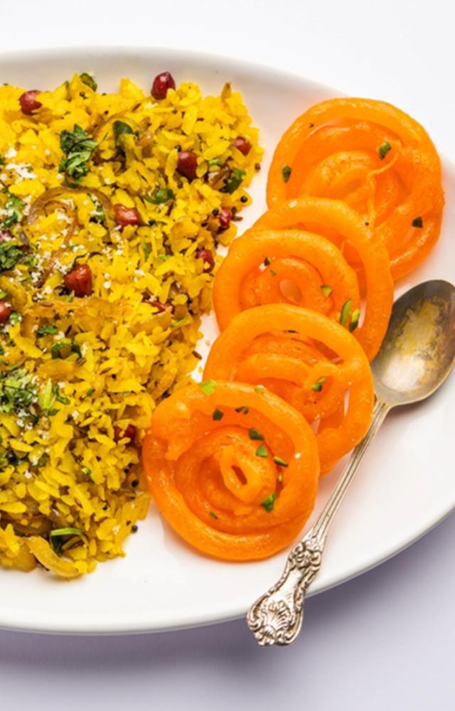 Indori Poha, emerged in Madhya Pradesh under Scindias and Holkars rulers, featuring Indori Sev, pomegranate, and the iconic Jalebi pairing.