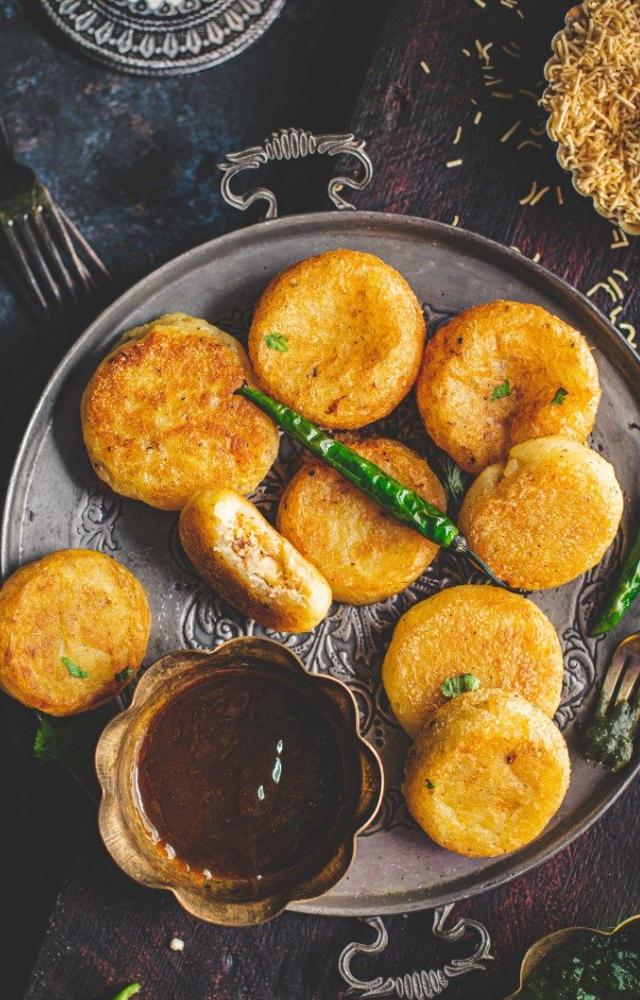 Khopra Patties, a delectable fusion of sweet and savory, are fried snacks crafted from potatoes, coconut, spices, and dry fruits