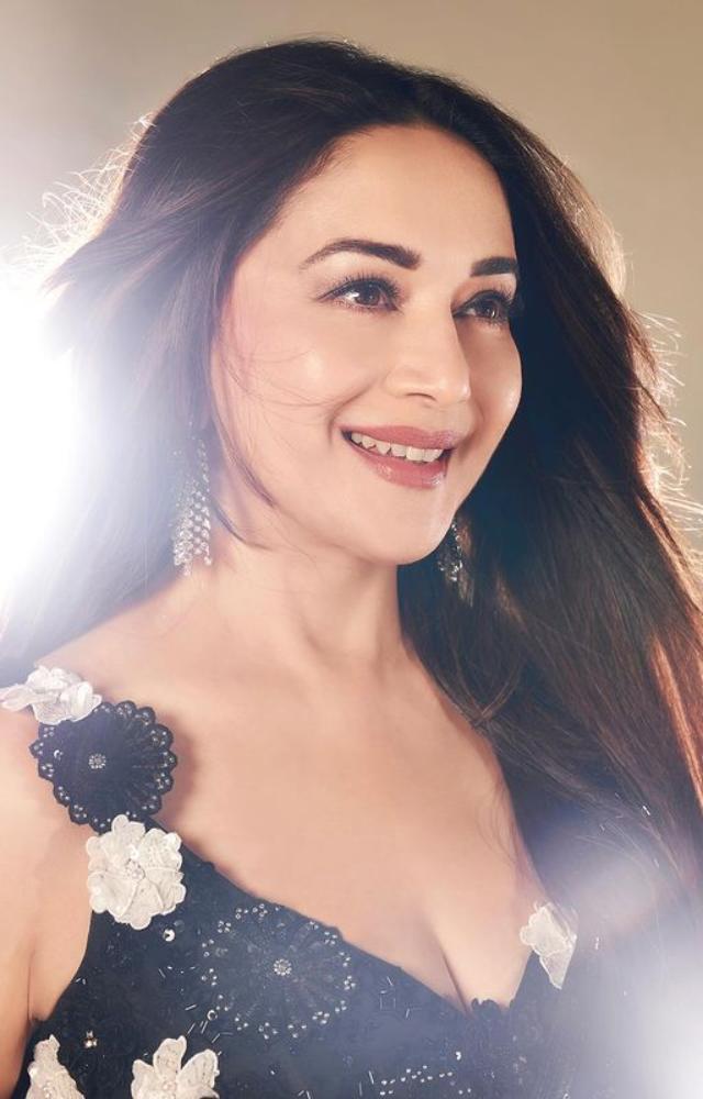Madhuri Dixit stuns in a black-themed photoshoot, exuding elegance and grace.