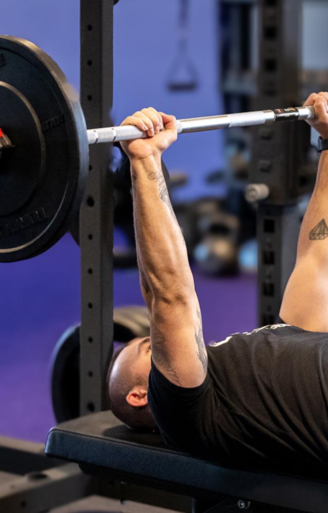 This traditional upper body exercise works the triceps, shoulders, and chest. Place a barbell over your chest while lying on a flat bench.