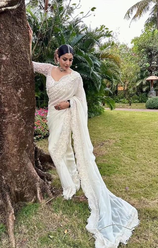 In a white floral saree, Raveena Tandon graces the photoshoot with timeless beauty, a vision of grace and style that mesmerizes.