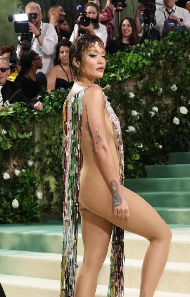 The hitmaker wore a pair of nude strappy heels with her rather provocative outfit, which had a multicolored overlay with tassels that touched the floor