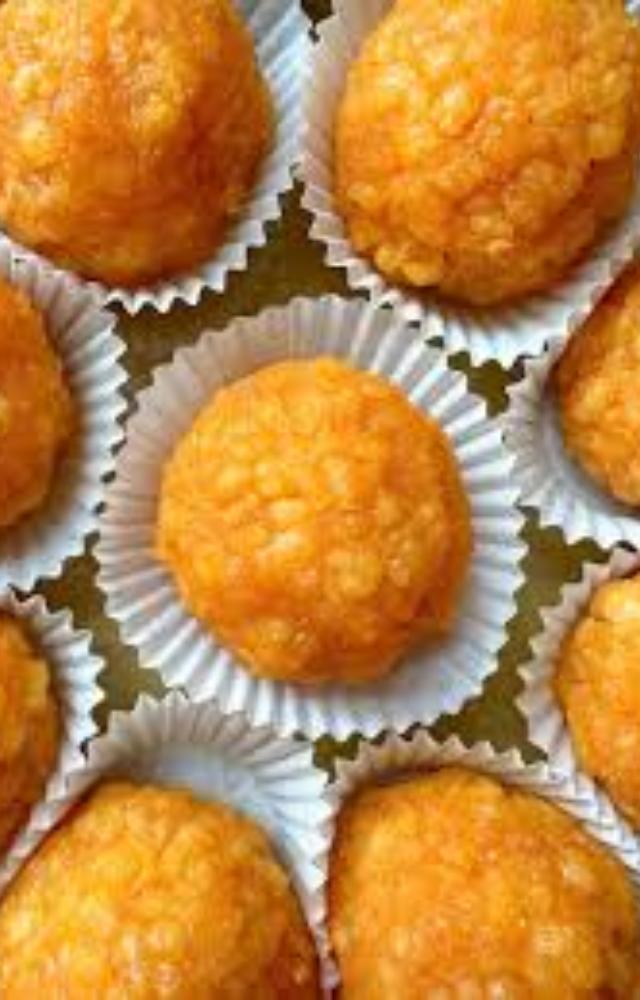 Round sweets made from various ingredients like besan and coconut, symbolizing joy and prosperity.