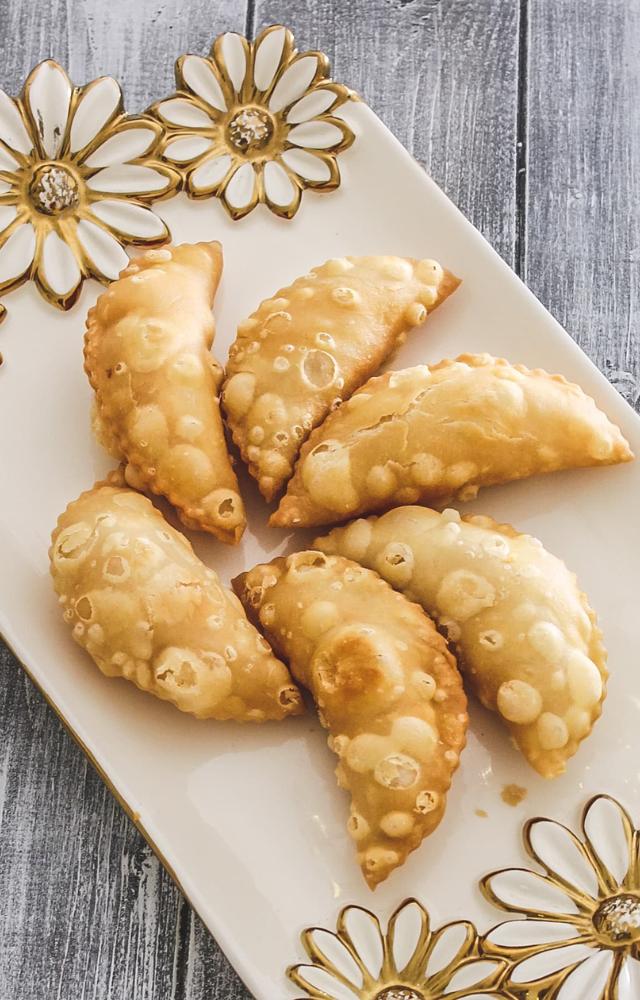 Sweet pastries filled with coconut and jaggery, deep-fried for a delightful crunch.