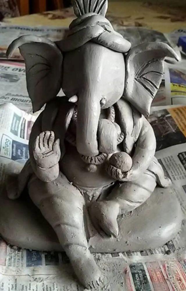 The journey begins with mixing natural clay with water, creating a malleable substance for sculpting the Ganesh idol.

