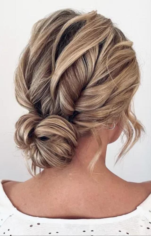 Master the perfect messy bun in under a minute. This go-to style is chic, quick, and effortless.
