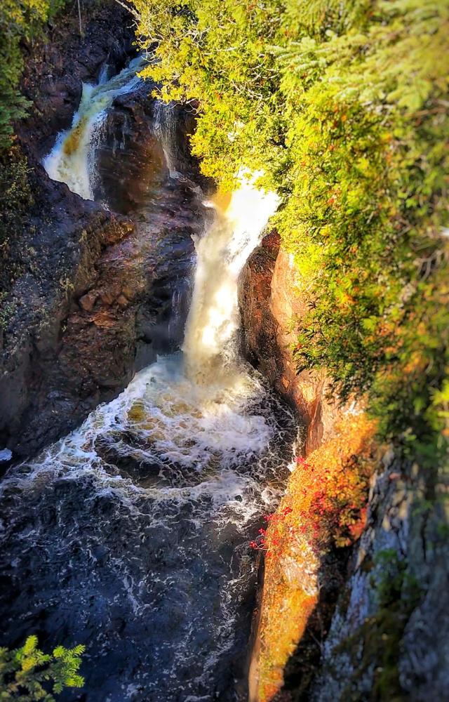 A mysterious waterfall where water disappears into a hole without a trace, baffling scientists.