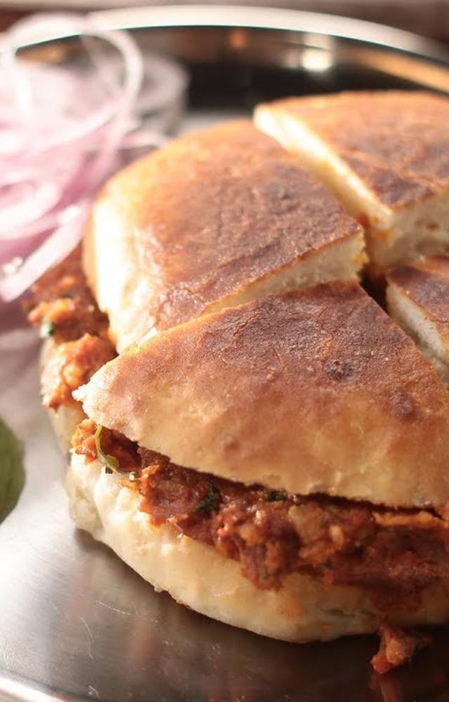 Savor the rich flavors of spiced chicken wrapped in a soft naan. A street food delight!