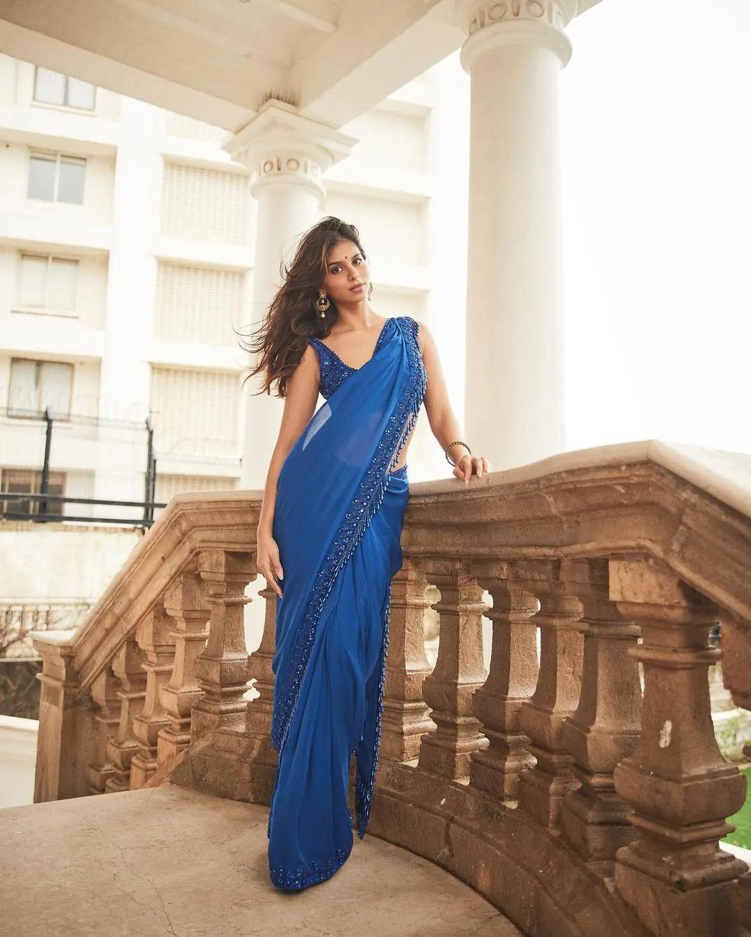 For a lightweight yet stylish look at your relative`s wedding, take inspiration from Suhana Khan`s elegant choice. Opt for a beautiful blue saree paired with a sequin blouse