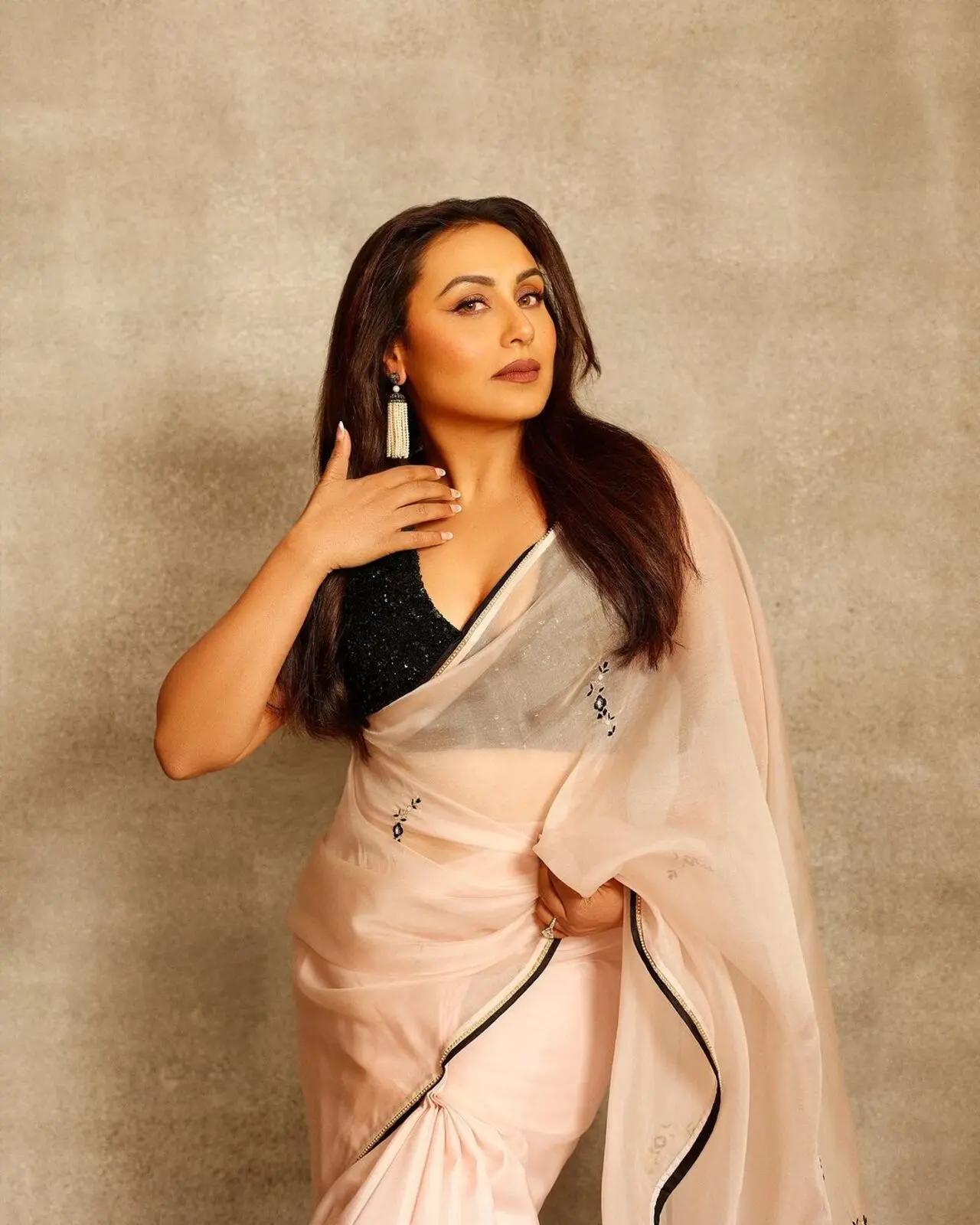 The actress wore the sheer white saree with a shiny black blouse with a deep neck