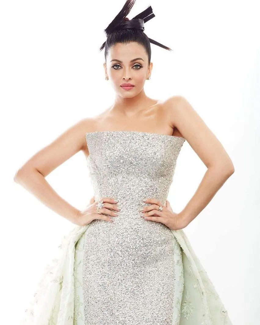 Aishwarya Rai Bachchan wore a shiny silver dress on the second day of the 2018 Cannes Film Festival. Her outfit was a strapless Rami Kadi gown with a sparkly blue train. She looked stunning as she walked the red carpet with her daughter Aaradhya.