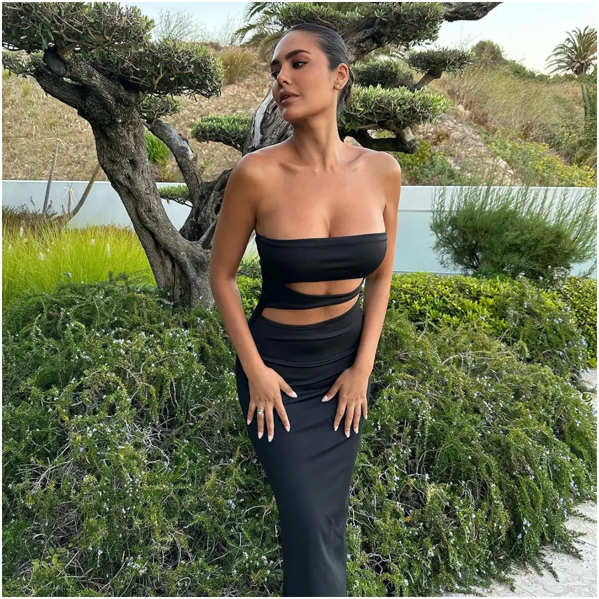 Showing us how to keep it fashionable in the midst of nature, Esha strikes a pose in this black cut-out dress in a serene location