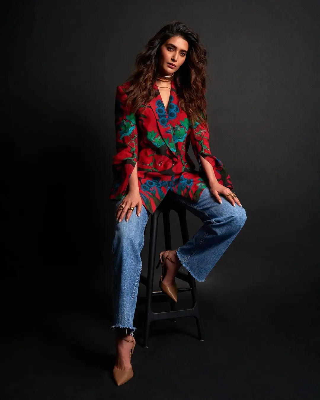 Matching colours effectively is indeed an art, and Karishma`s look provides some valuable inspiration in this regard. She made a striking fashion statement by pairing a stunning red and green blazer with blue jeans, showcasing her keen sense of style and color coordination