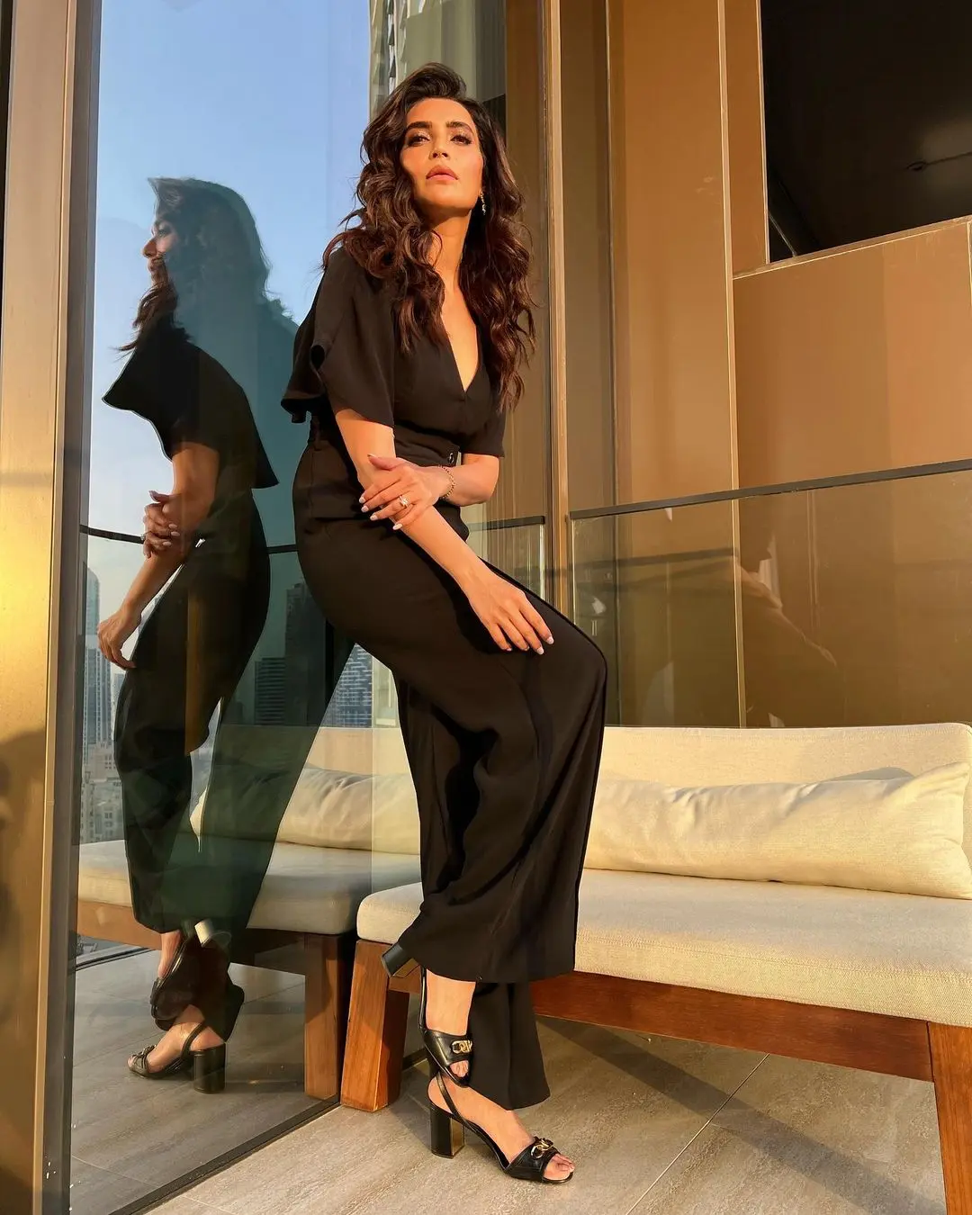 Karishma`s choice of a black jumpsuit for her workday outfit is a classic and timeless option. Paired with matching heels and chic earrings, her ensemble exudes a powerful and bossy aura