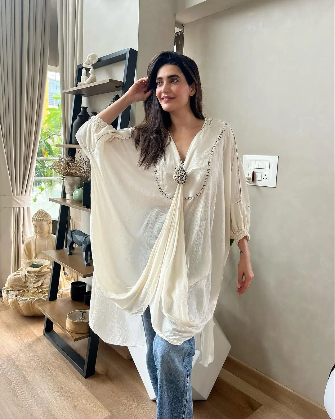 When you`re not in the mood for anything else, you can always rely on traditional attire. Karishma Tanna`s choice of a white stylish kurta paired with blue jeans is an absolutely perfect pick for your office look