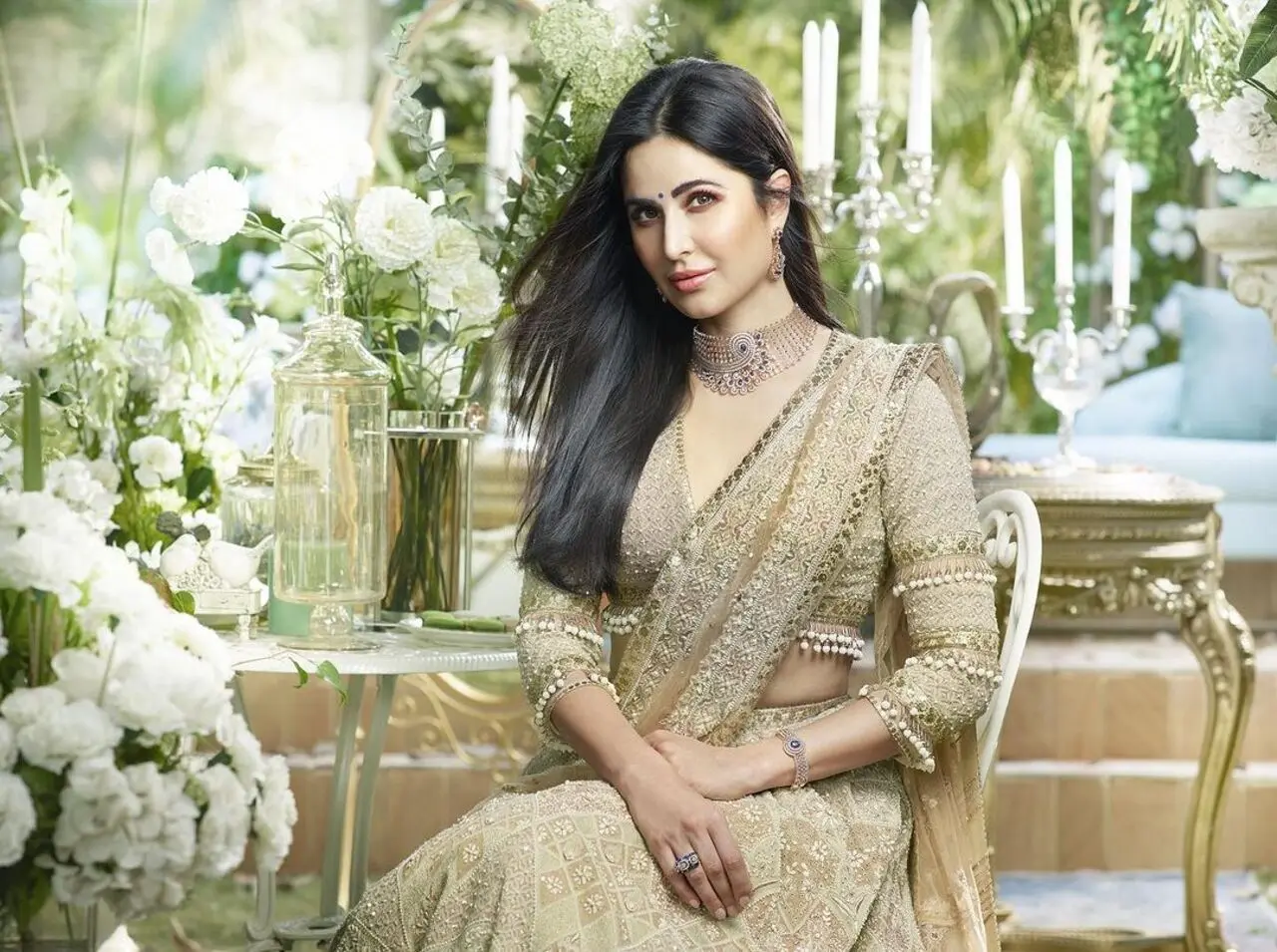 This heavily embroidered golden saree on Katrina Kaif offers a stunning look for Karva Chauth. The sparkly saree, paired with beautifully intricate accessories, makes this outfit truly stand out